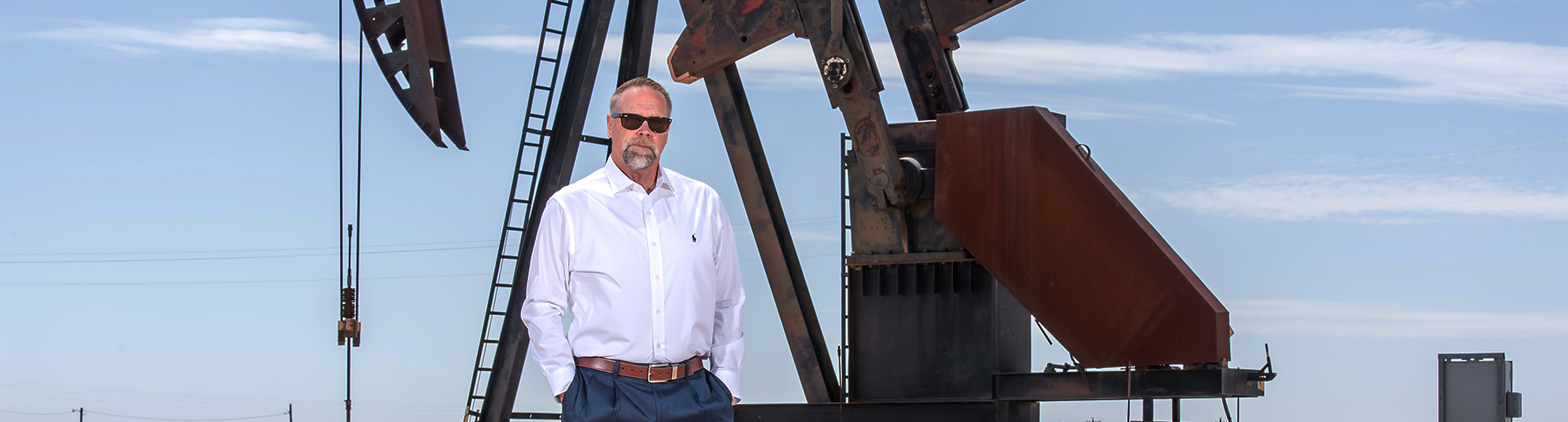 image of banker standing by oil rig in Lovington, NM