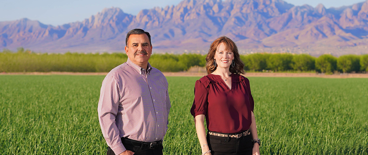 Image of two people with mountains in background