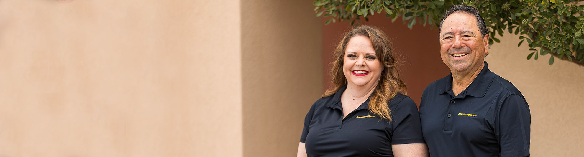 female and male banker smiling