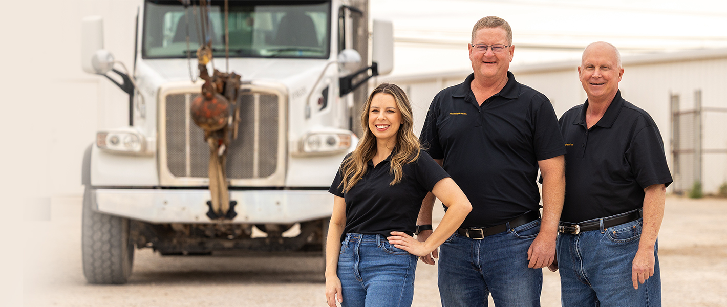Three bankers standing in front of a crane